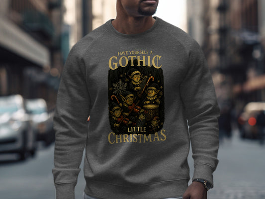 Dark heather Gothic Little Christmas sweatshirt with vintage elf band artwork under gold text. Unisex fleece crewneck blending dark Victorian charm with festive spirit. Premium print quality from The Print Harbour UK.