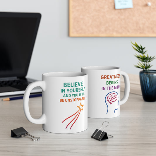 Two mugs showing Believe in Yourself and Greatness Begins in the Mind on a desk setup by The Print Harbour