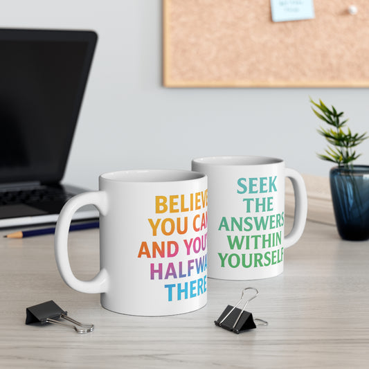 Dual-sided motivational mug on desk showing Believe You Can and Seek The Answers Within Yourself by The Print Harbour